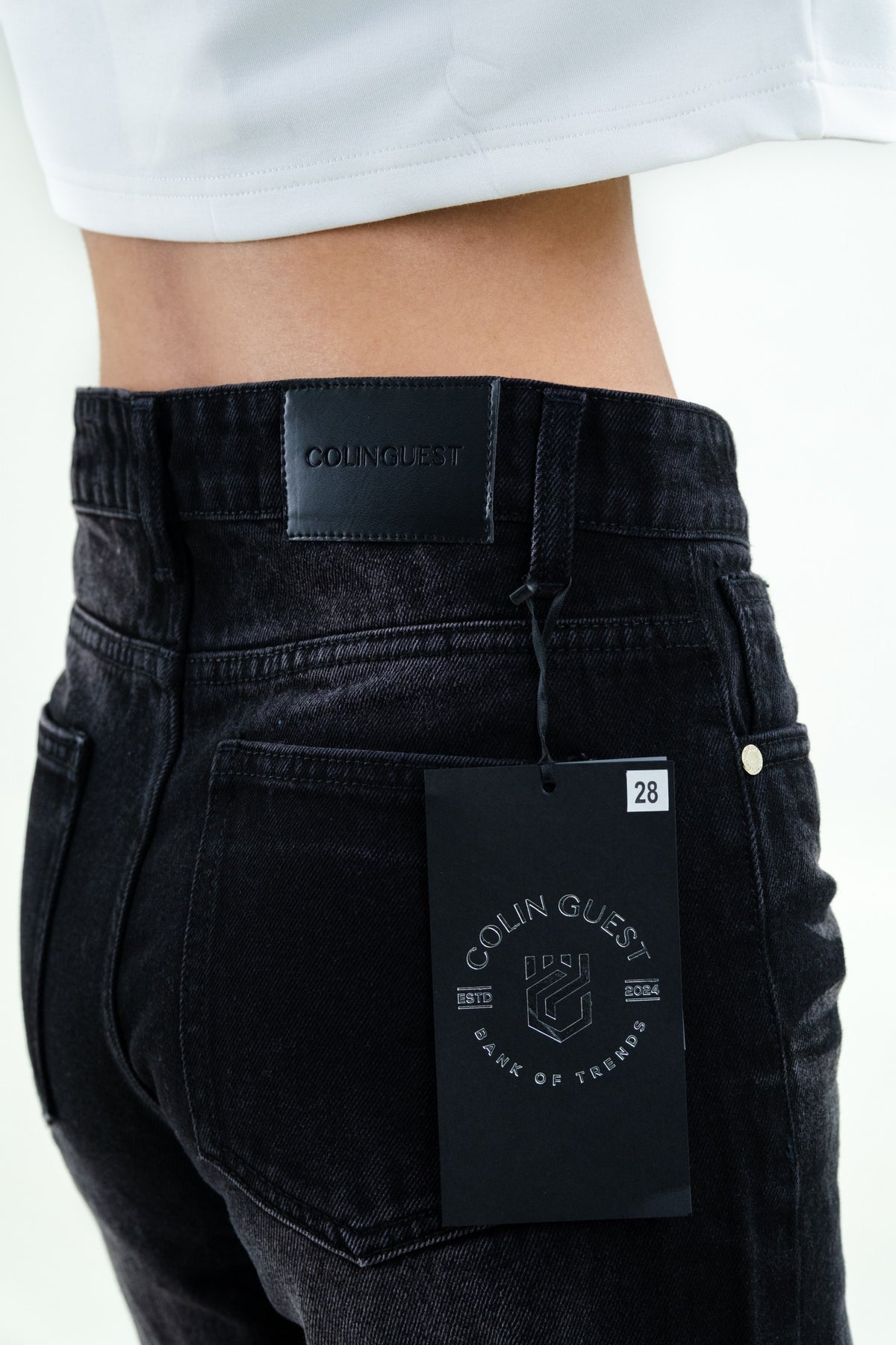 Black faded jeans waistband and pocket detail